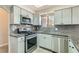 Well-lit kitchen featuring modern appliances, gray cabinets, and granite countertops at 508 Indian Princess Dr # 104, Las Vegas, NV 89145