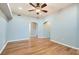Open-plan living room with wood floors, ceiling fan, and archways to other rooms at 508 Indian Princess Dr # 104, Las Vegas, NV 89145