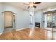Open-concept living room with fireplace, hardwood floors, and a slider door to a patio at 508 Indian Princess Dr # 104, Las Vegas, NV 89145