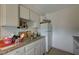 This functional kitchen features white cabinets, laminate countertops and a gas range at 5228 Pebble Beach Blvd, Las Vegas, NV 89108