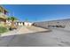 Spacious parking area with partial block wall around the apartment complex at 5228 Pebble Beach Blvd, Las Vegas, NV 89108