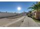 Extended parking area with palm trees and partial block wall around the complex at 5228 Pebble Beach Blvd, Las Vegas, NV 89108