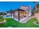 Inviting backyard with a covered patio, outdoor bar, and refreshing pool at 5501 Painted Sunrise Dr, Las Vegas, NV 89149