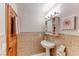 Bathroom featuring classic tilework, pedestal sink, and decorative accents at 5501 Painted Sunrise Dr, Las Vegas, NV 89149
