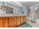 Bathroom featuring a double vanity, tiled shower, and modern fixtures at 5501 Painted Sunrise Dr, Las Vegas, NV 89149