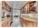 Butler's pantry with granite counters, upper glass cabinets and a wine refrigerator at 5501 Painted Sunrise Dr, Las Vegas, NV 89149
