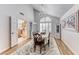 Bright dining room with chandelier, hardwood floors and a view to the kitchen at 5501 Painted Sunrise Dr, Las Vegas, NV 89149