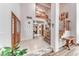 Inviting foyer with tiled floors, a wooden staircase, and ample natural light, creating a grand entrance at 5501 Painted Sunrise Dr, Las Vegas, NV 89149