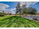 Beautiful golf course landscape with manicured grass, scattered trees, and blue sky, showcasing a serene and open environment at 5501 Painted Sunrise Dr, Las Vegas, NV 89149