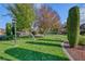 Lush green space with mature trees and manicured lawn, providing a serene and inviting atmosphere at 5501 Painted Sunrise Dr, Las Vegas, NV 89149
