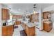 Kitchen with granite countertops, custom cabinets, and an island cooktop at 5501 Painted Sunrise Dr, Las Vegas, NV 89149