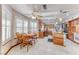 Spacious kitchen and breakfast nook featuring tile floors, wood cabinets, granite countertops, and modern lighting at 5501 Painted Sunrise Dr, Las Vegas, NV 89149