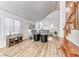 Open-concept living area with high ceilings, wood floors, and staircase access at 5501 Painted Sunrise Dr, Las Vegas, NV 89149