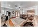 Bright and spacious living room with hardwood floors, fireplace, and access to the kitchen and backyard at 5501 Painted Sunrise Dr, Las Vegas, NV 89149