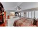 Cozy main bedroom boasts a fireplace, shuttered windows, ceiling fan, and soft carpeting at 5501 Painted Sunrise Dr, Las Vegas, NV 89149
