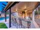 Stylish outdoor kitchen with a granite countertop bar, seating, and a built-in grill, great for entertaining at 5501 Painted Sunrise Dr, Las Vegas, NV 89149