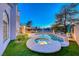 Backyard with a luxurious pool, spa and covered patio with dining set and bar area at 5501 Painted Sunrise Dr, Las Vegas, NV 89149