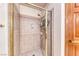 Bathroom's shower room featuring tile walls, glass door and gold hardware at 5501 Painted Sunrise Dr, Las Vegas, NV 89149