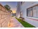 Landscaped side yard with a brick wall, planter box, and paved walkway at 5501 Painted Sunrise Dr, Las Vegas, NV 89149