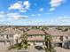 An aerial view of houses with clay tile roofs and well-maintained landscaping in a suburban setting at 5578 Holcomb Bridge Ct, Las Vegas, NV 89149