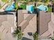 Aerial view of multiple houses with pools and desert landscaping in the backyards at 5578 Holcomb Bridge Ct, Las Vegas, NV 89149