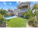 View of backyard oasis with large pool, manicured lawn, and palm trees at 5578 Holcomb Bridge Ct, Las Vegas, NV 89149