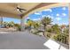 Expansive covered balcony providing serene views of lush landscaping and tropical palm trees at 5578 Holcomb Bridge Ct, Las Vegas, NV 89149