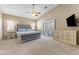 Comfortable bedroom featuring plush carpeting, elegant furnishings, and bright, shuttered windows at 5578 Holcomb Bridge Ct, Las Vegas, NV 89149