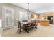 Open floorplan of dining room with views to the kitchen with stainless steel appliances and island at 5578 Holcomb Bridge Ct, Las Vegas, NV 89149