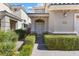 Charming home entrance with a manicured hedge pathway leading to the front door at 5578 Holcomb Bridge Ct, Las Vegas, NV 89149