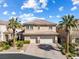Beautiful two-story home with a two-car garage, palm trees, and a well-maintained lawn at 5578 Holcomb Bridge Ct, Las Vegas, NV 89149