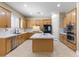 Bright kitchen with a center island, stainless steel appliances and recessed ceiling lights at 5578 Holcomb Bridge Ct, Las Vegas, NV 89149