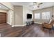 Inviting living room with modern ceiling fan, stylish wood-look floors, and bright, shuttered windows at 5578 Holcomb Bridge Ct, Las Vegas, NV 89149