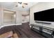 Upstairs living room with wood floors, view of the loft, and large mounted TV at 5578 Holcomb Bridge Ct, Las Vegas, NV 89149