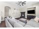 Comfortable living room with a large gray sofa, a modern fireplace, and sleek hardwood floors at 5578 Holcomb Bridge Ct, Las Vegas, NV 89149