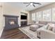Inviting living room showcasing a modern fireplace, gray sectional sofa, and plenty of natural light at 5578 Holcomb Bridge Ct, Las Vegas, NV 89149