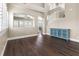 Spacious living room featuring hardwood floors, staircase, and natural light from large windows at 5578 Holcomb Bridge Ct, Las Vegas, NV 89149