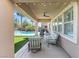 Covered patio features outdoor seating with views of the green backyard and pool at 5578 Holcomb Bridge Ct, Las Vegas, NV 89149