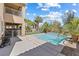 Backyard pool with waterfall feature and green turf at 5578 Holcomb Bridge Ct, Las Vegas, NV 89149