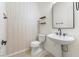 Stylish powder room featuring a pedestal sink, decorative mirror, and modern accents at 5578 Holcomb Bridge Ct, Las Vegas, NV 89149