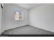 The bright secondary bedroom has neutral carpet and a nice window at 5733 Crenellated St # Lot 67, Las Vegas, NV 89148