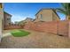Fully fenced backyard with low maintenance gravel landscaping and artificial turf at 5829 Feral Garden St, North Las Vegas, NV 89031