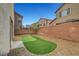 Fully fenced backyard with low maintenance gravel landscaping and artificial turf at 5829 Feral Garden St, North Las Vegas, NV 89031