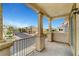 Spacious balcony featuring decorative columns and a wrought iron railing overlooking a quiet street at 5829 Feral Garden St, North Las Vegas, NV 89031
