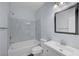 Bathroom with a shower-tub combo, white vanity, and modern fixtures at 5829 Feral Garden St, North Las Vegas, NV 89031