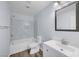 Modern bathroom with tiled shower-tub combo, modern vanity, and chrome fixtures at 5829 Feral Garden St, North Las Vegas, NV 89031