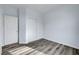 Bedroom with wood-look floors, sliding closet doors, and neutral paint at 5829 Feral Garden St, North Las Vegas, NV 89031