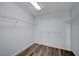 Walk-in closet with organized shelving and wood-look flooring at 5829 Feral Garden St, North Las Vegas, NV 89031