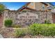 Stone entryway sign for Apple Creek community, complemented by manicured landscaping and shrubbery at 5829 Feral Garden St, North Las Vegas, NV 89031
