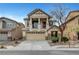 Inviting two-story home featuring a charming balcony, stone accents, and a well-maintained front yard at 5829 Feral Garden St, North Las Vegas, NV 89031